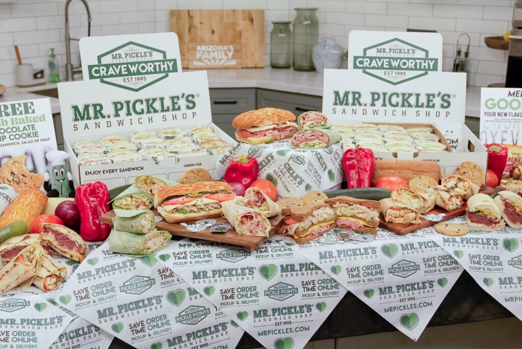 A collection of the wraps, sandwiches, and sides available at Mr. Pickle’s, arranged carefully on a table.